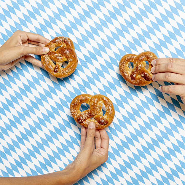 Close-up of German pretzels on a blue and white Bavarian background